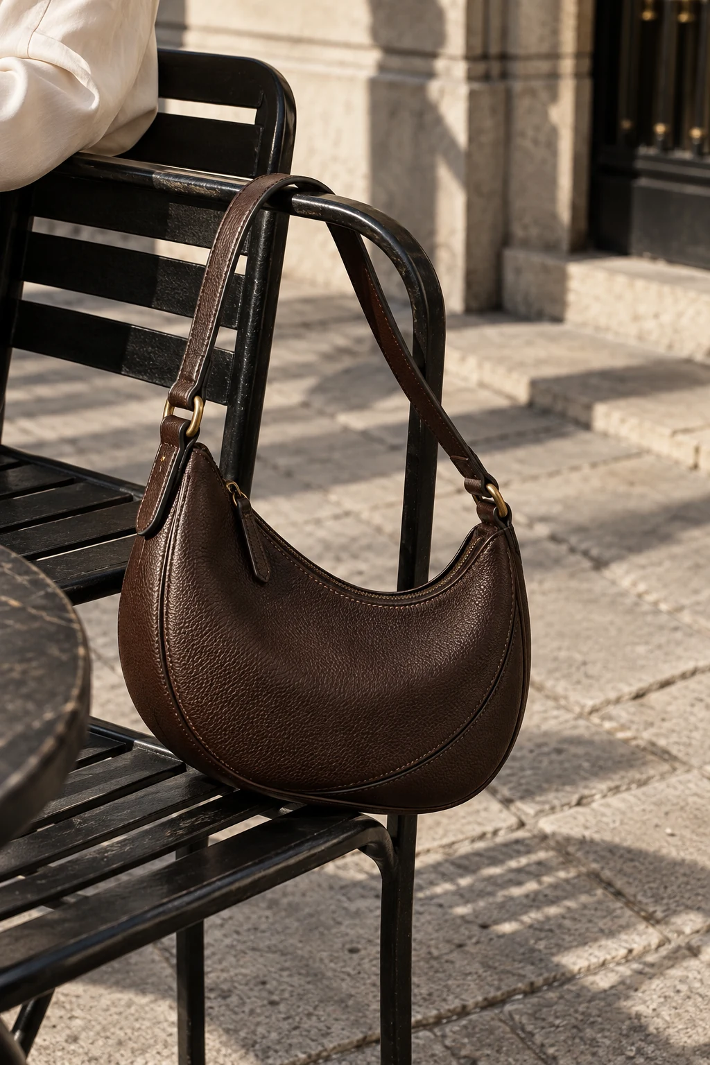 Chocolate crescent bag on a café chair